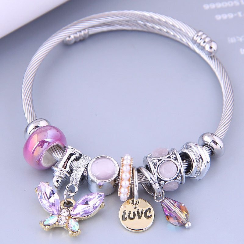 This bangle is BEAUTIFUL and full of charm! Hypoallergenic and skin friendly. Adorned with lovely lavender stones, pearls and crystals. This bracelet is stretchy and comfortable to wear. Great for everyday wear. This piece a great gift.  **If gifting this to a friend or loved one, add that on the notes at check out. This item will be gift wrapped in a gift box at no charge!